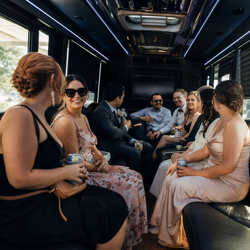 Wedding guests seated inside a Dallas party bus