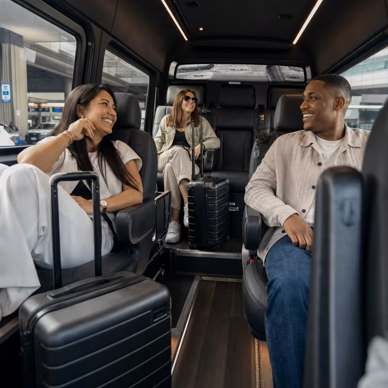Passengers loading luggage while boarding an Dallas group shuttle
