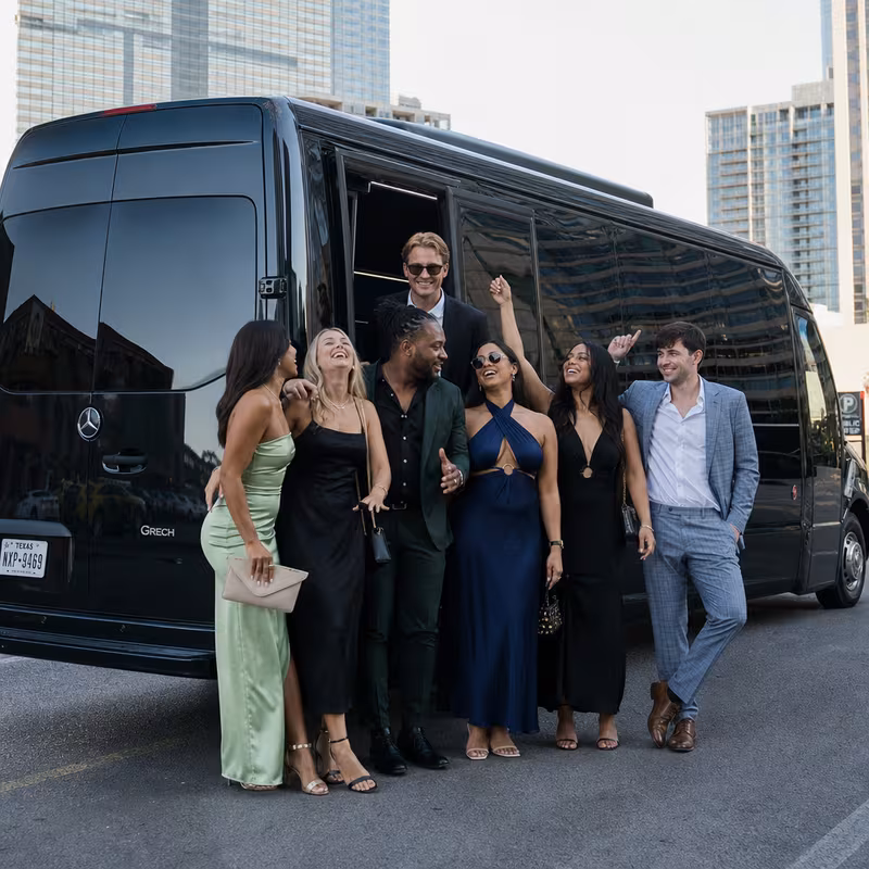 Group boarding a white charter bus for Bachelor & Bachelorette Transportation transportation in Dallas