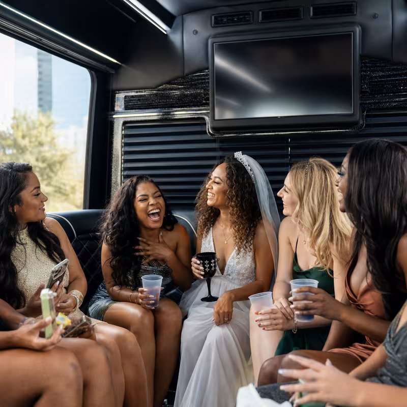 Party bus interior with wraparound leather seating and LED lighting in Dallas