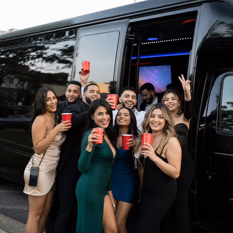Group boarding a white charter bus for Birthday Transportation transportation in Dallas