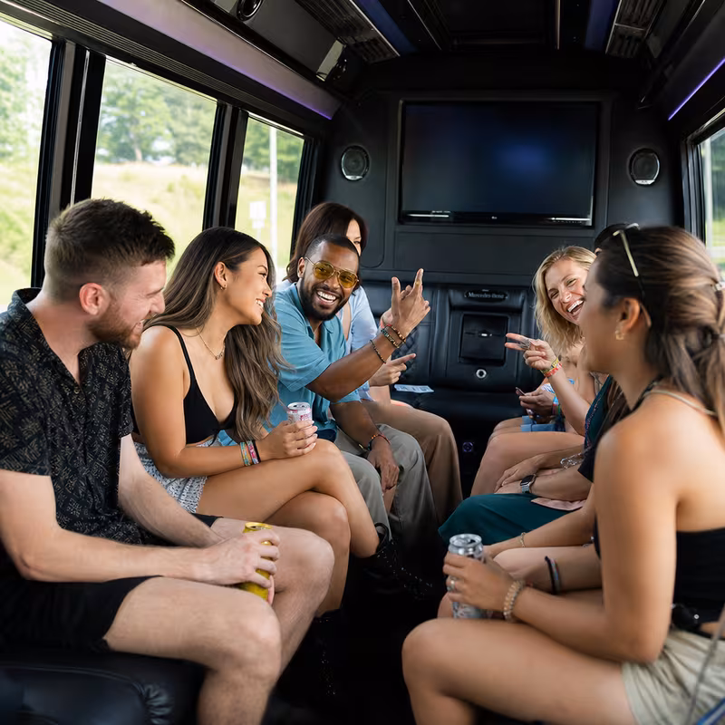 Group boarding a white charter bus for Concert Transportation transportation in Dallas