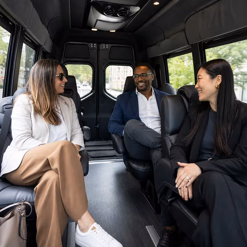 Group boarding a white charter bus for Corporate Transportation transportation in Dallas