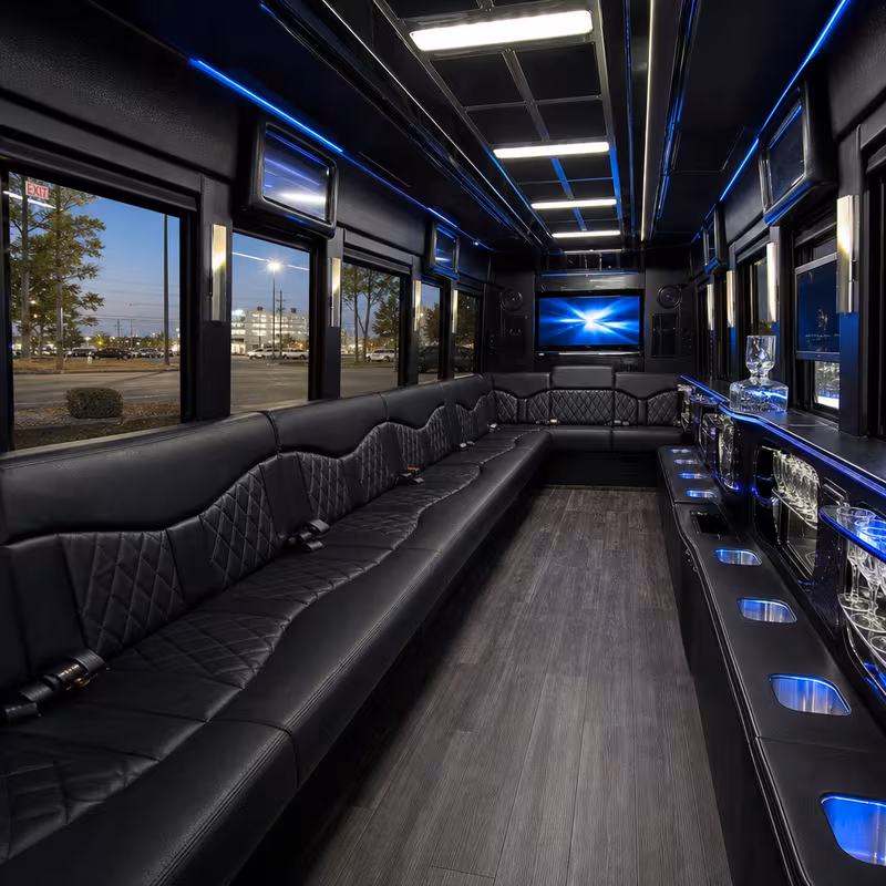 Party bus interior with wraparound leather seating and LED lighting in Dallas