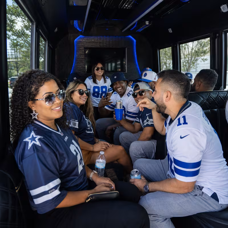 Group boarding a white charter bus for Sporting Event Transportation transportation in Dallas