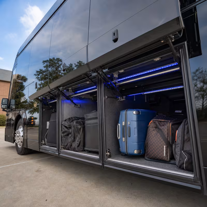 Party bus interior with wraparound leather seating and LED lighting in Dallas