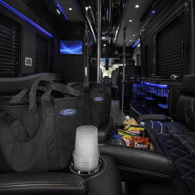 Party bus interior with wraparound leather seating and LED lighting in Dallas